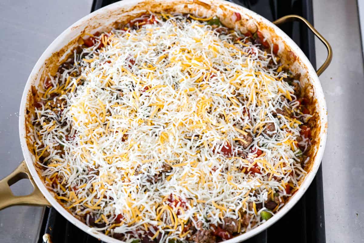 Okay, but can we talk about how gorgeous this taco skillet is?! Like, if dinner could be a showoff, this would be it. Itโs giving melty, cheesy, golden perfection, and the best part? It all comes together in one pan. Cheese added to the top of the skillet.