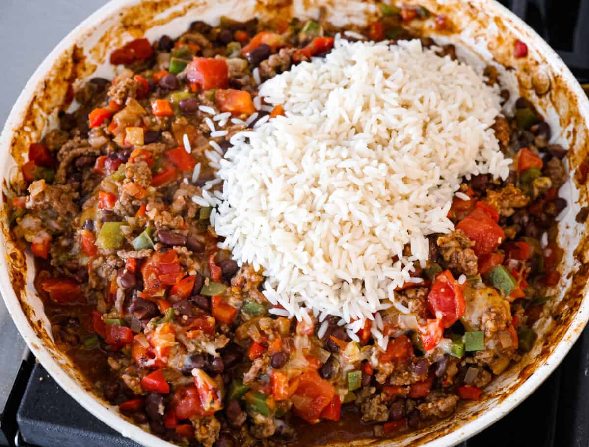 Okay, but can we talk about how gorgeous this taco skillet is?! Like, if dinner could be a showoff, this would be it. Itโs giving melty, cheesy, golden perfection, and the best part? It all comes together in one pan. Rice added to the skillet.
