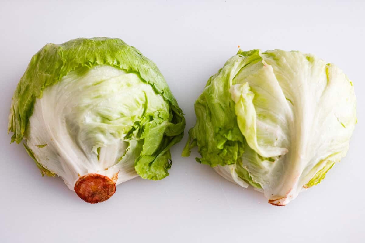 This classic wedge salad brings all the steakhouse vibes! Piled high with crispy bacon, fresh tomatoes, and a drizzle of creamy blue cheese dressing, it's a simple side that goes with just about anything. Head of lettuce cut in half.