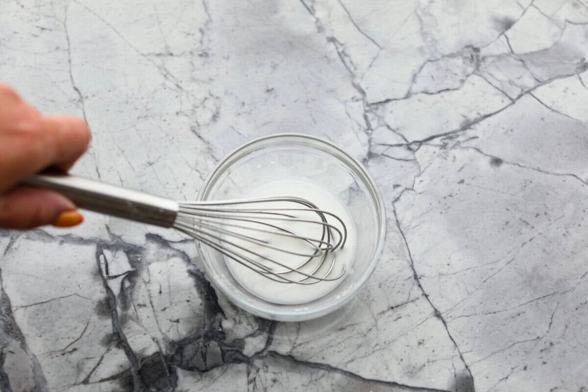 Iโve tested a lot of sweet and sour sauces, and this is the one I always come back to. My recipe uses pineapple juice for that perfect tangy-sweet balance, and itโs ready in minutes with pantry staples. Someone whisking together the cornstarch slurry.