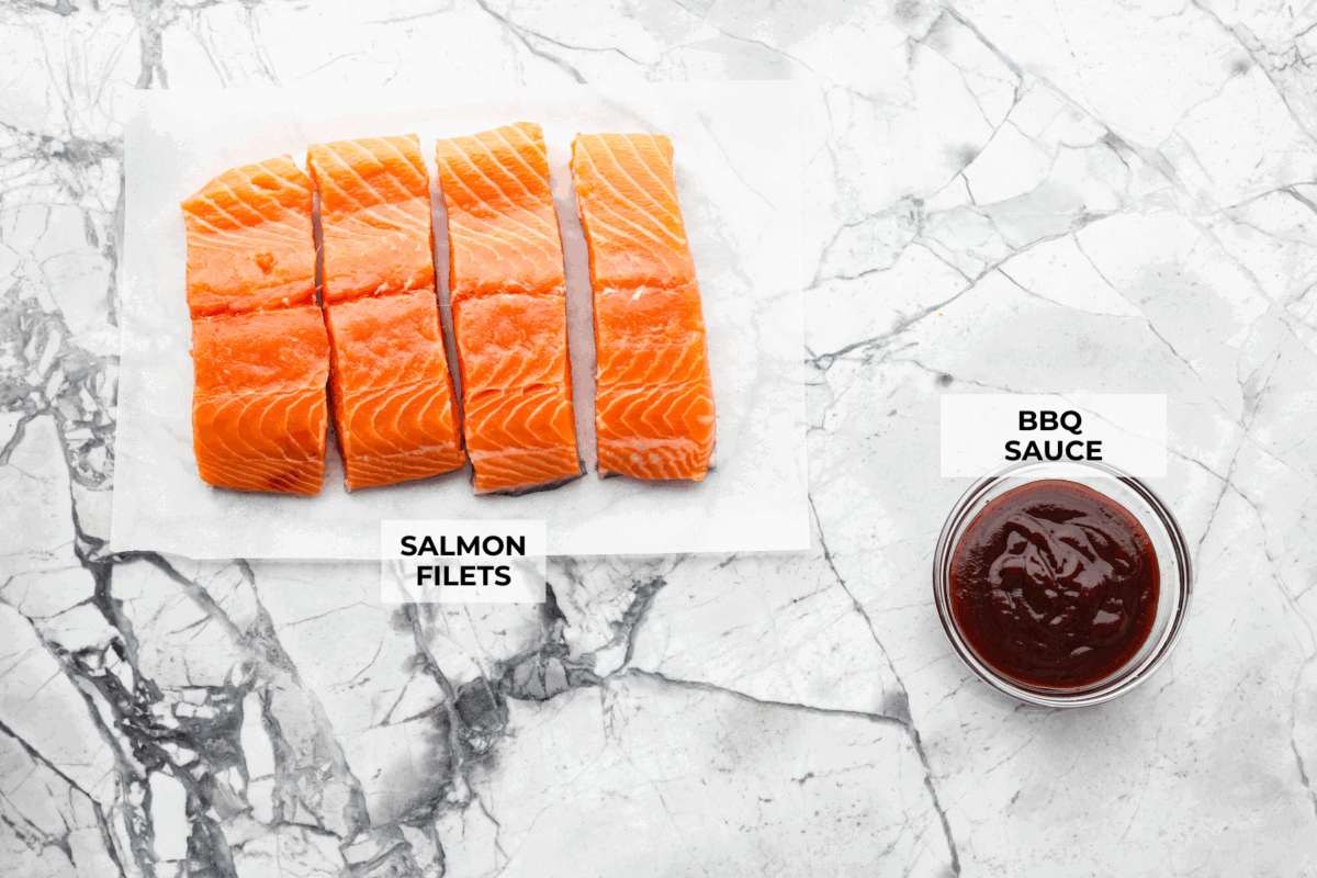 You guys know I'm obsessed with salmon! This BBQ salmon is perfectly smoky, tender, and coated in my mouthwatering homemade barbecue sauce. Overhead shot of labeled ingredients.