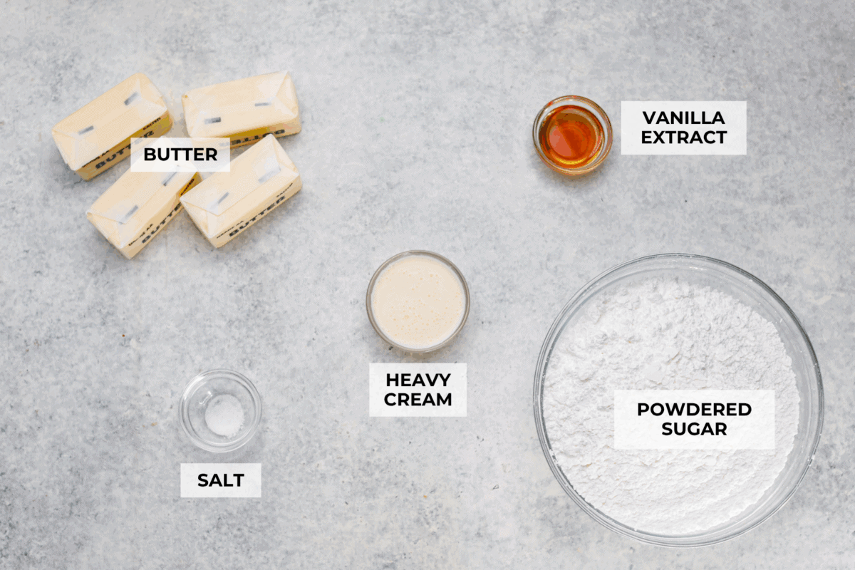Let me just say, when it comes to frosting, I know what I’m doing. I’ve whipped, piped, and taste-tested my way through more buttercream frosting than I care to admit, and this one? It’s the gold standard. Overhead shot of labeled buttercream frosting ingredients.