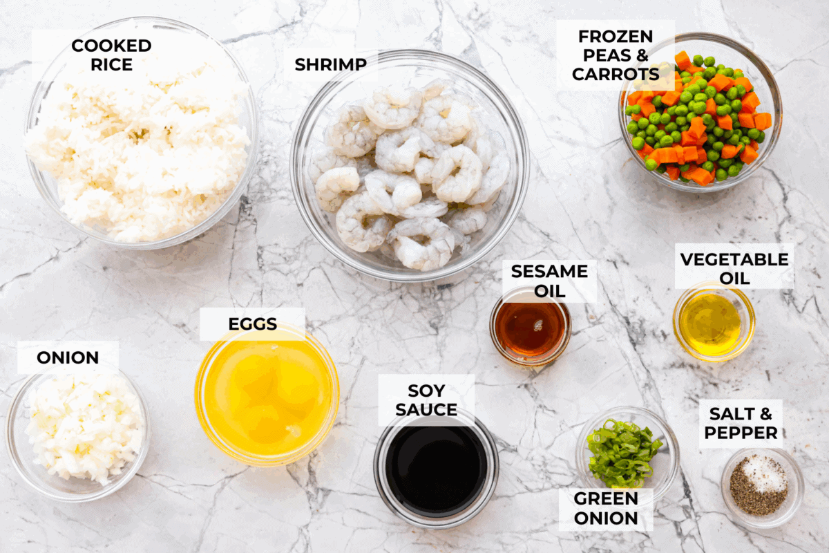 Skip the takeout! This shrimp fried rice is faster, fresher, and way more flavorful! Juicy shrimp, tender veggies, fluffy rice, and scrambled eggs all come together in one irresistible skillet meal. Overhead shot of labeled ingredients.
