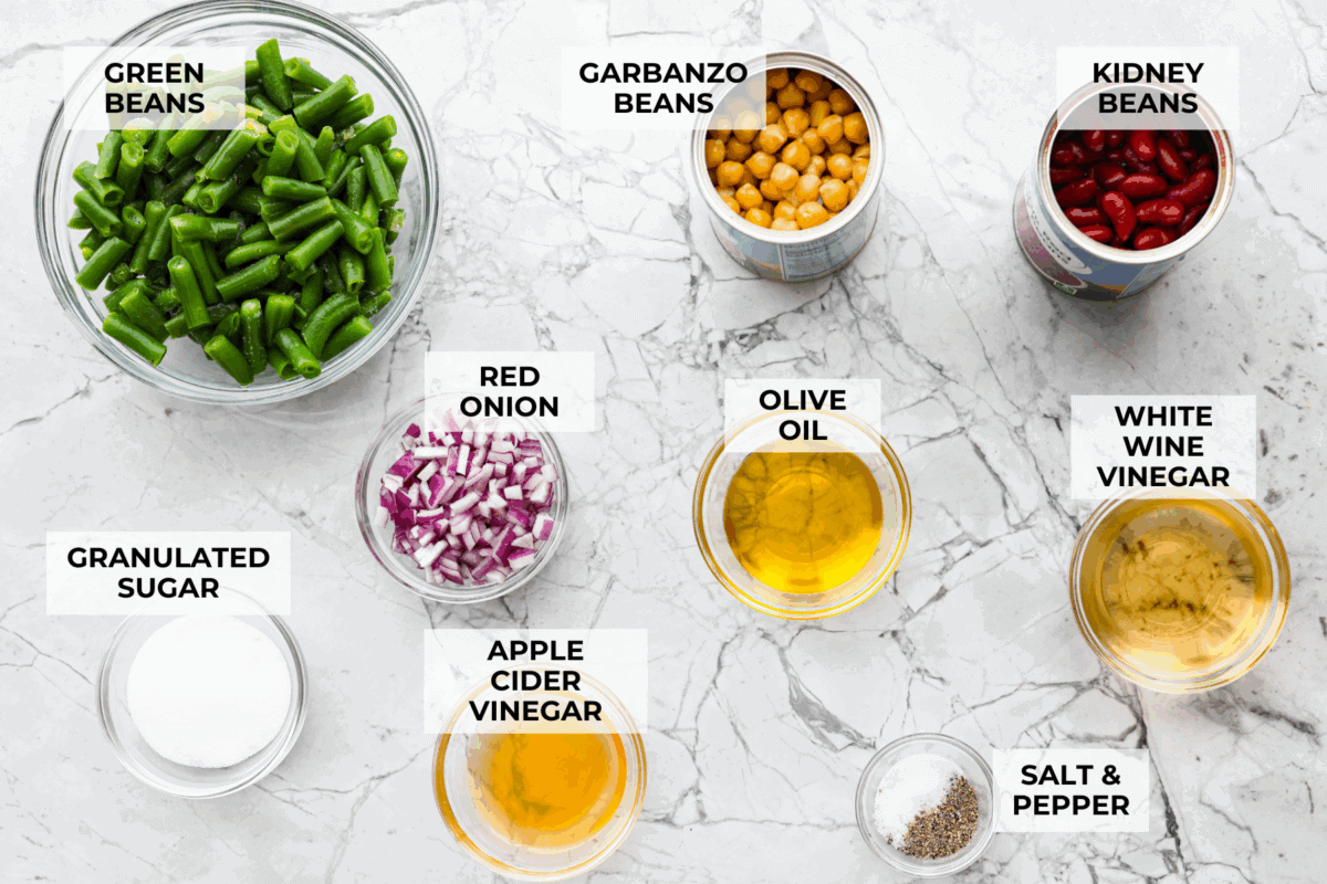 Iโve been adding fiber into my meals, and this three bean salad makes it way too easy. Itโs packed with fiber, and still tastes like a treat! It's tangy, a little sweet, and even better the next day. Overhead shot of labeled ingredients.
