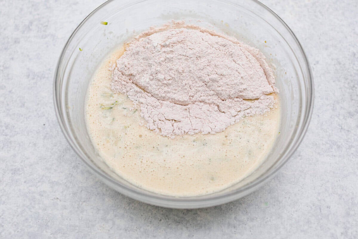 You better believe I count down to zucchini season so I know when I can make this delicious Zucchini Bread! It’s moist, perfectly spiced, and loaded with the best flavor and a hint of veggies! Dry ingredients added to the zucchini and wet ingredient mixture.