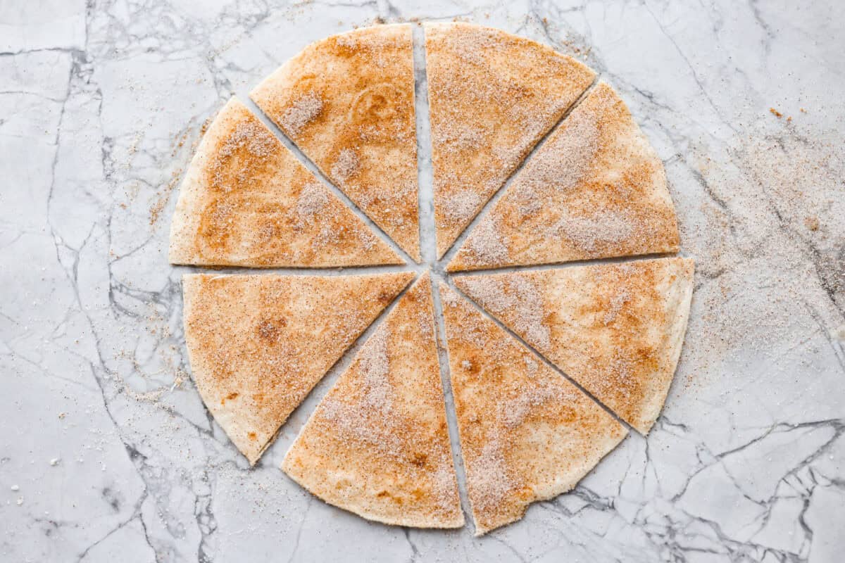 You have to try these cinnamon sugar tortilla chips! They're sweet, crispy, and totally addictive. They’re perfect for scooping up your favorite dessert dips or gobbling them down on their own! Tortilla with cinnamon and sugar cut into triangles.