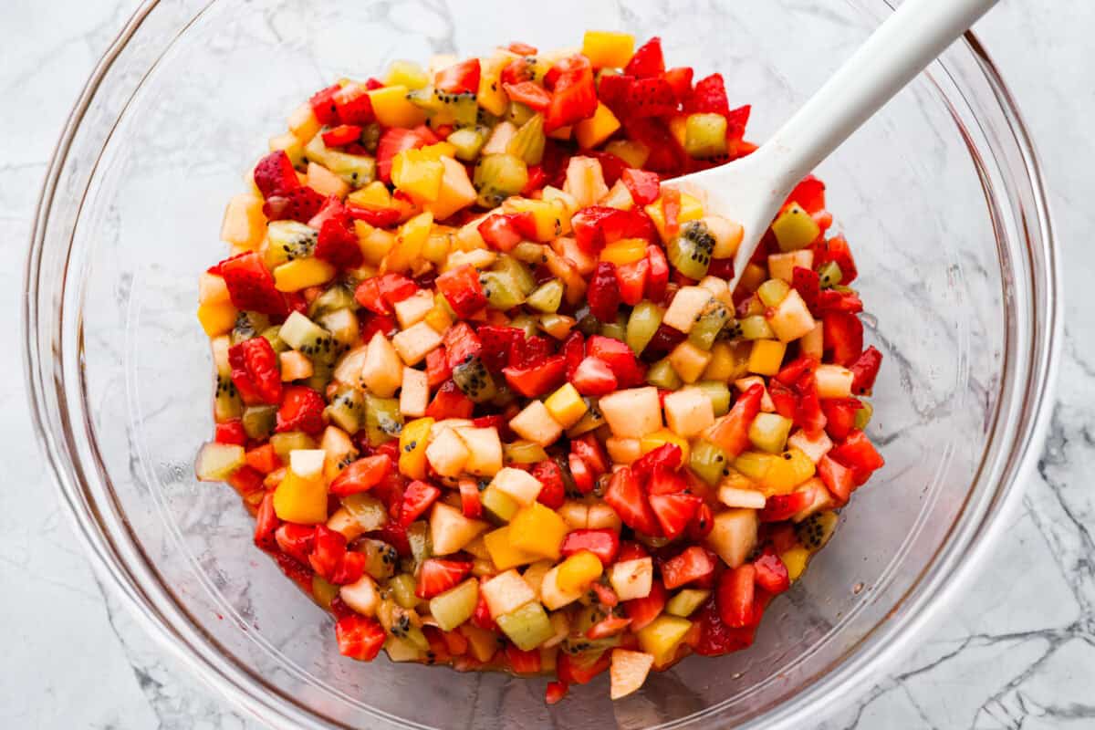 Vibrant fruit salsa is a fresh, juicy twist on your favorite snack! Sweet berries, tropical mango, and a splash of lime alwaysย steal the spotlight! Especially when served with crispyย cinnamon chips! Raspberry jam mixed in with the diced fruit.