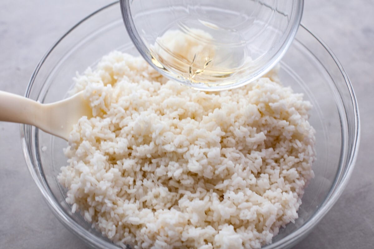My simple Sushi Bake has all the flavors you love about sushi in an easy, no-roll casserole-style dish. Itโs faster, more affordable, and perfect for feeding a crowd without sacrificing that sushi fix. Adding the sugar and vinegar mixture to the cooked rice.