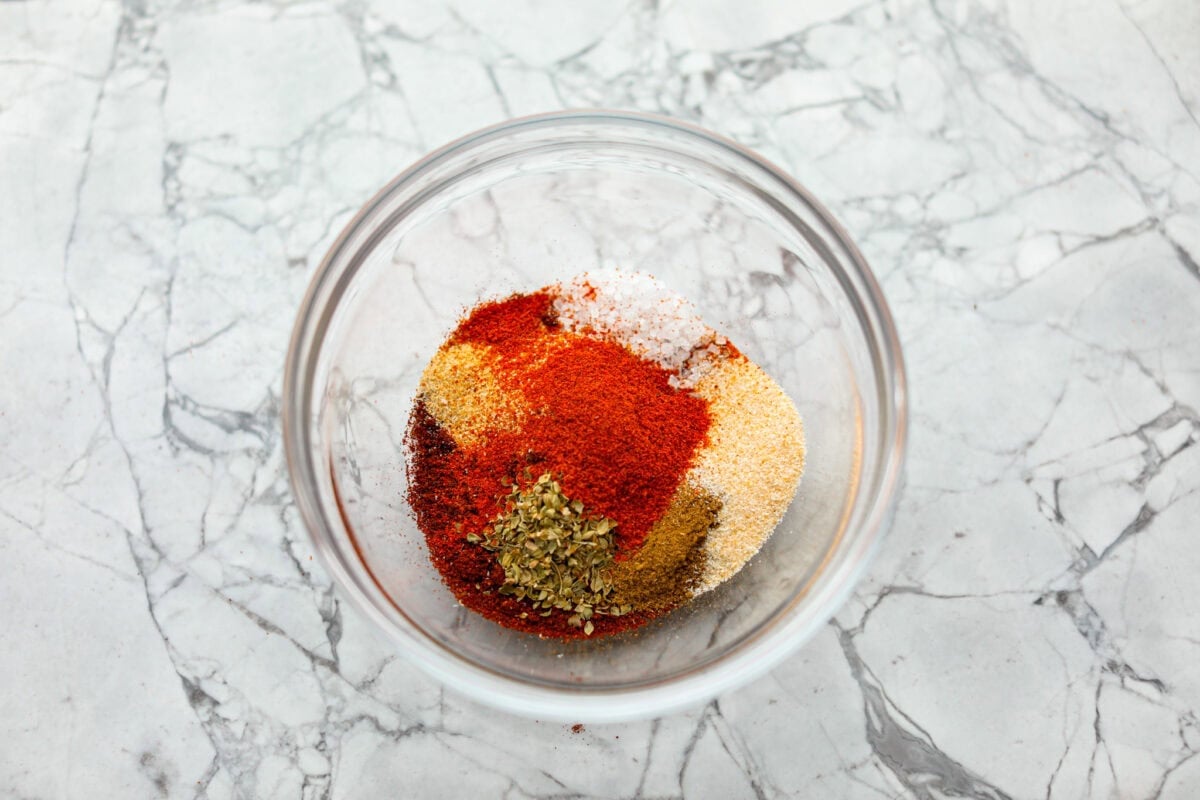 Okay, this homemade fajita seasoning is seriously next-level. I mix it up with pantry spices I always have on hand, and it makes everything taste better! Chicken, steak, veggies, you name it. Bowl of fajita seasoning ingredients.