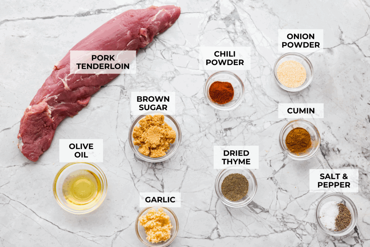 Air fryer pork tenderloin is the ultimate weeknight dinner hero! It's quick, juicy, and packed with flavor! It cooks up perfectly with minimal effort, thanks to a simple marinade and the magic of the air fryer. Overhead shot of labeled ingredients.