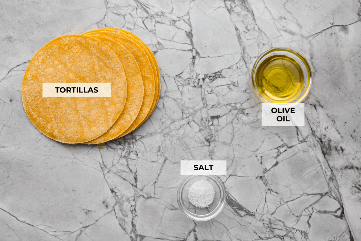 You know that moment when you’ve inhaled a basket of chips and salsa and realize… you just ate five tortillas? Yeah, same. These air fryer tortilla chips are crispy, golden, and practically guilt-free. Overhead shot of labeled ingredients.