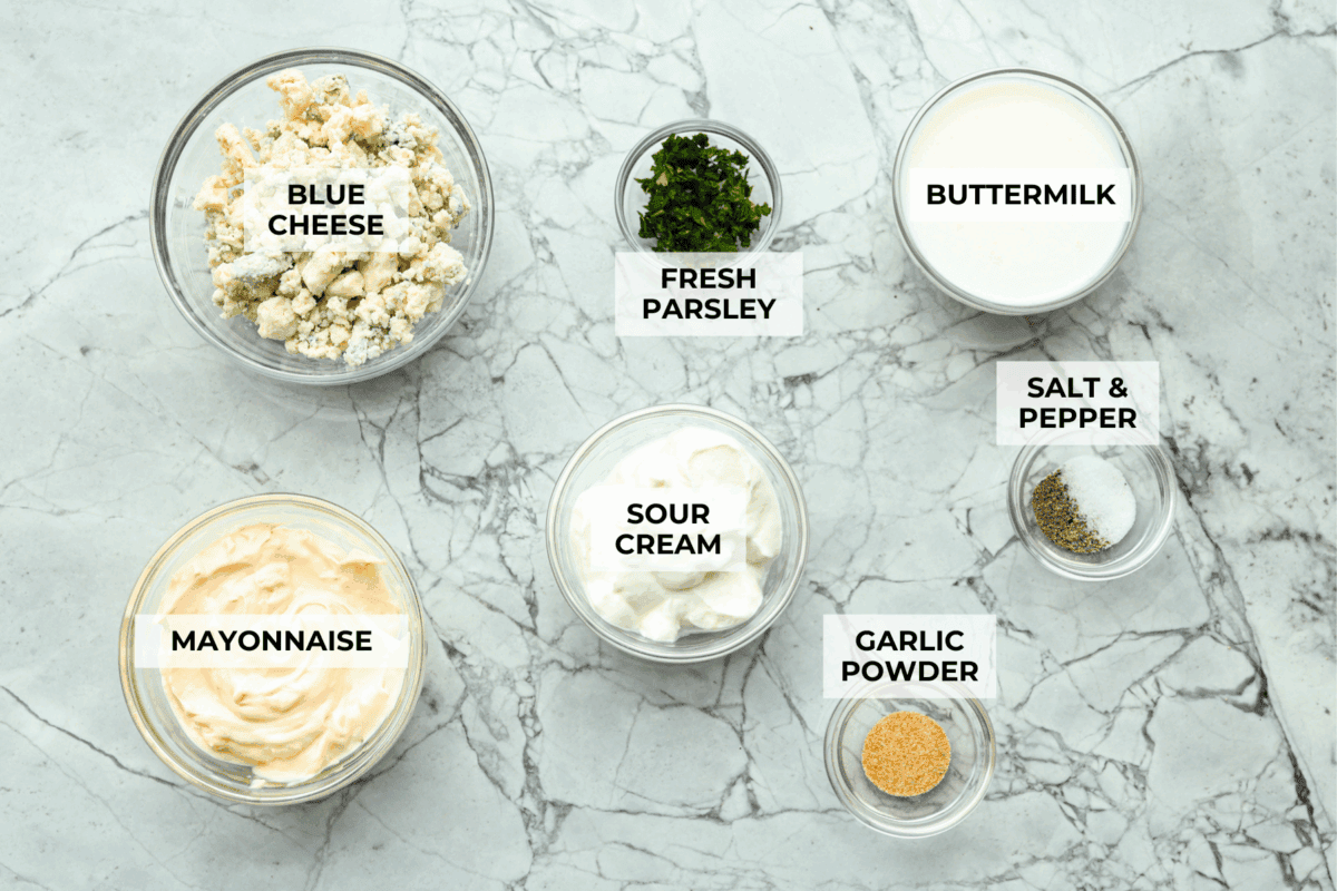 Once you try this homemade blue cheese dressing, thereโs no going back to store-bought! Itโs the perfect cool and creamy drizzle for wings, salads, and more. Overhead shot of labeled ingredients.