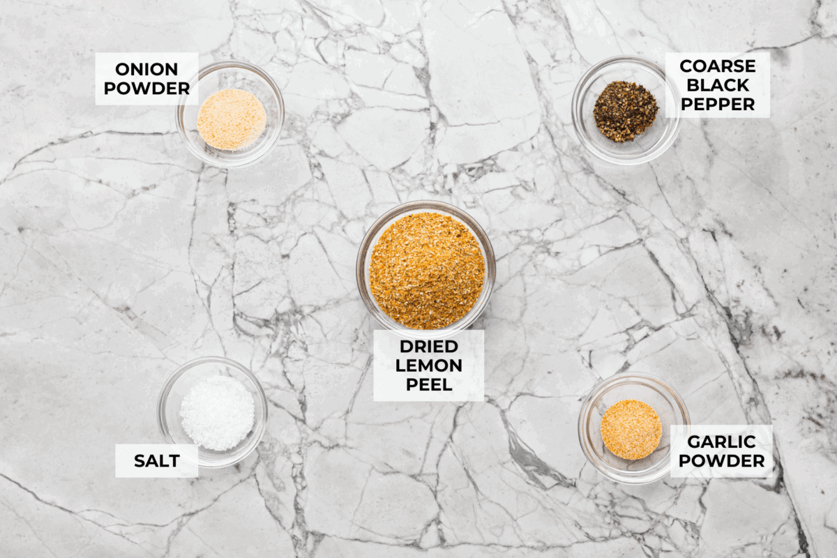 If you’ve never made your own lemon pepper seasoning before, get ready, this stuff is bold, zesty, and so much better than store-bought. The best part? You can make the dried lemon peel from scratch, and I'll teach you how! Overhead shot of labeled ingredients.