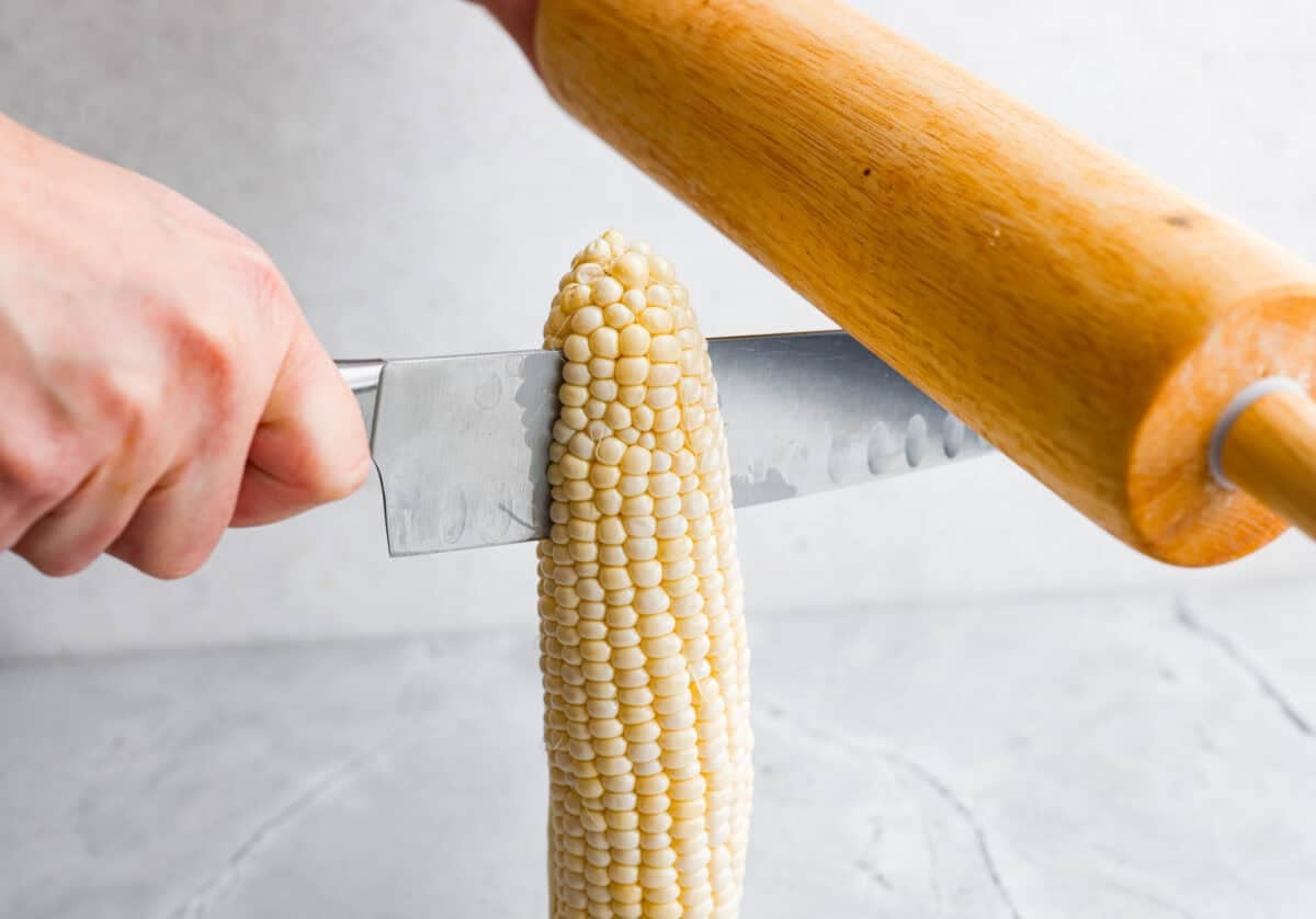 I had to try these viral Corn Ribs, and now I totally get the hype! They're fun, handheld, and smothered in creamy, zesty Mexican street corn flavor. Make a batch to share... or donโt. I wonโt judge. someone hitting the back of a knife blade to get the knife to go through the corn cob.