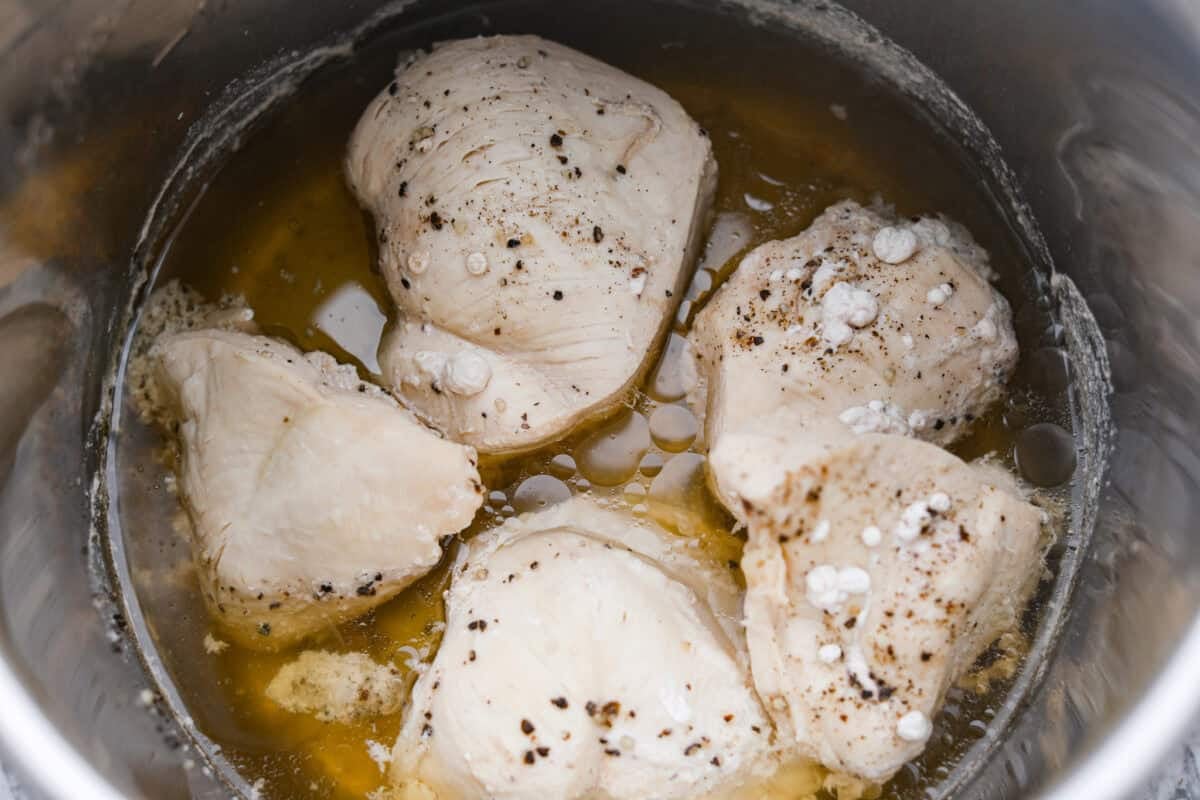 Forgot to thaw the chicken? No problem! This instant pot frozen chicken recipe turns rock-solid breasts into tender, juicy perfection in no time. Dinner crisis averted! Cooked chicken in teh instant pot.