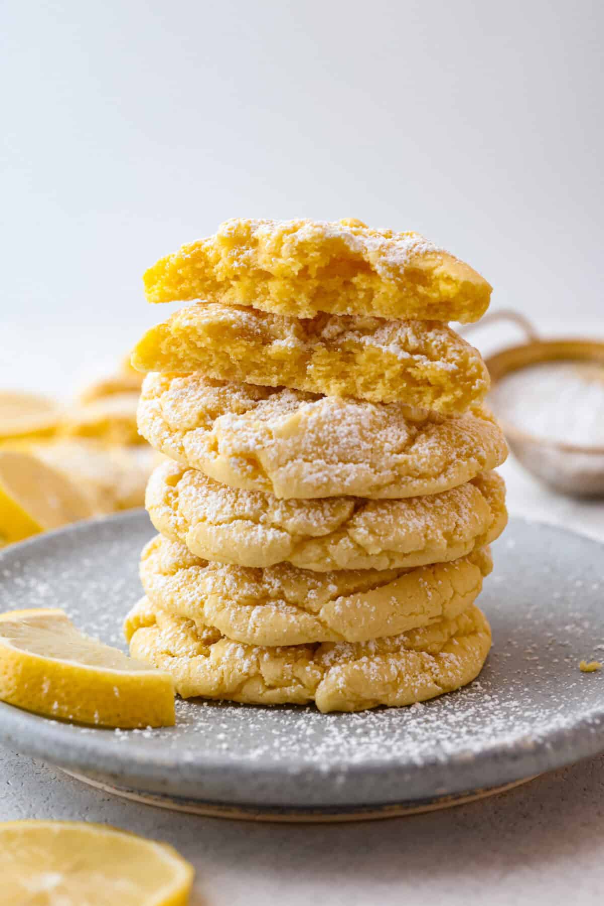 My Lemon Cake Mix Cookies are the shortcut your sweet tooth has been waiting for. Using a cake mix means you can enjoy soft, lemony cookies with a bakery-style texture in a fraction of the time. Side shot of a stack of lemon cake mix cookies.