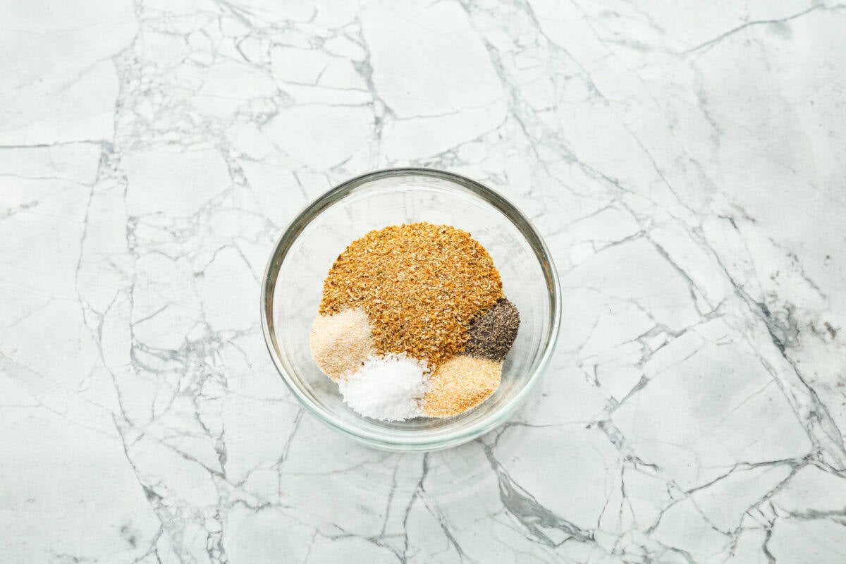 If you’ve never made your own lemon pepper seasoning before, get ready, this stuff is bold, zesty, and so much better than store-bought. The best part? You can make the dried lemon peel from scratch, and I'll teach you how! Bowl of individual ingredients in separate piles.