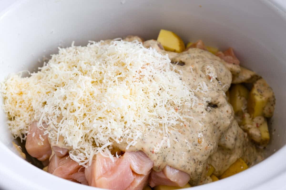 This viral slow cooker Parmesan garlic chicken has juicy meat, tender potatoes, and a sauce so rich and creamy that scooping it with a spoon wonโt cut it. Youโll want to drink it, or letโs be real, bathe in it. Sauce, cheese and broth added to the slow cooker.