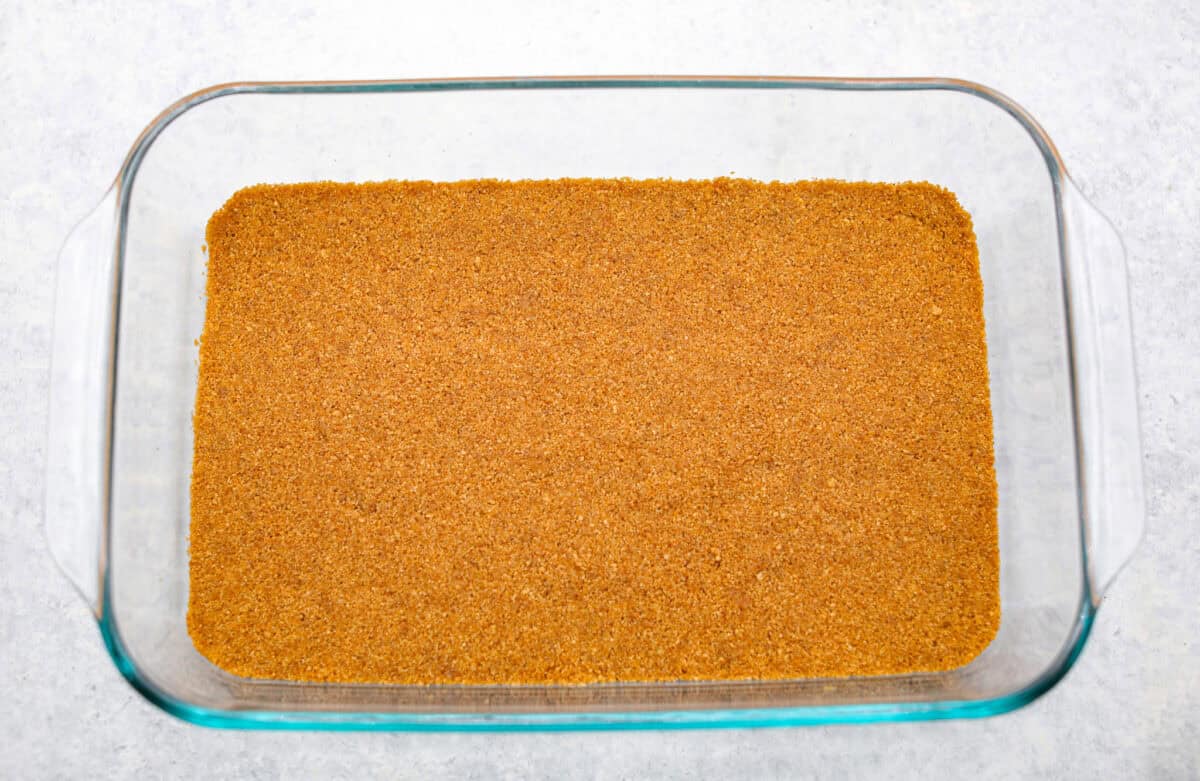 Caramel Apple Pie Lush is the easiest fall dessert you’ll ever make! With layers of buttery crust, creamy cheesecake, spiced apples, caramel, and whipped topping, it’s a yummy fall treat that is so much easier than baking a pie from scratch! Graham cracker crumb mixture smashed into the bottom of the pan for the crust.