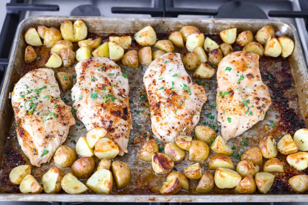 Baked buttery herb chicken with potatoes is pure comfort on a plate! I love tossing everything together in one pan and letting it cook! It saves time and lets all those delicious flavors meld for the juiciest, flavorful chicken and soft, savory potatoes. Chicken and potatoes baked with fresh herbs sprinkled over the top.