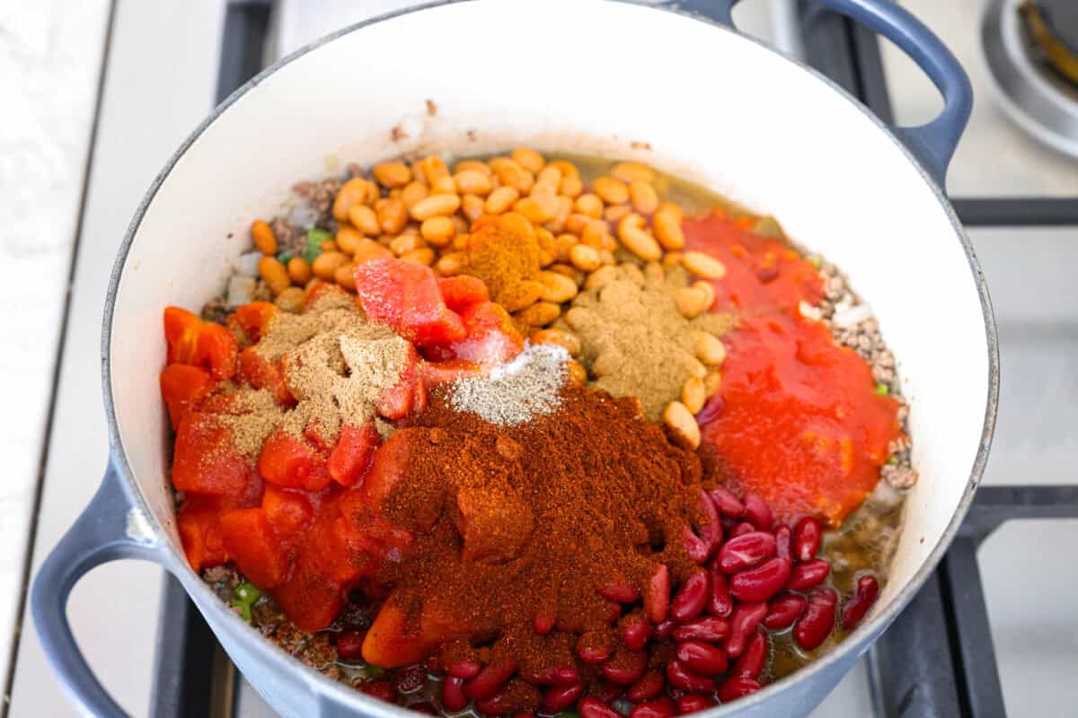 I'm telling you right now, this is the BEST chili you will ever have. The reviews don't lie! It's hearty, flavorful, and oh-so-comforting. It's packed with ground beef, beans, tomatoes, and bold spices. Get creative with your toppings and dig in! Beans, tomatoes and other seasonings added to the beef mixture in the pot.