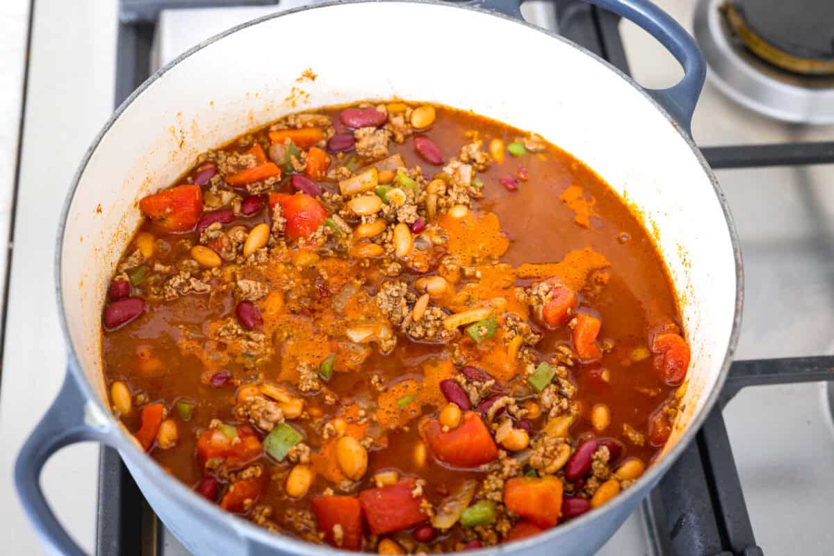 I'm telling you right now, this is the BEST chili you will ever have. The reviews don't lie! It's hearty, flavorful, and oh-so-comforting. It's packed with ground beef, beans, tomatoes, and bold spices. Get creative with your toppings and dig in! All of the ingredients all stirred together and simmering in the pot.