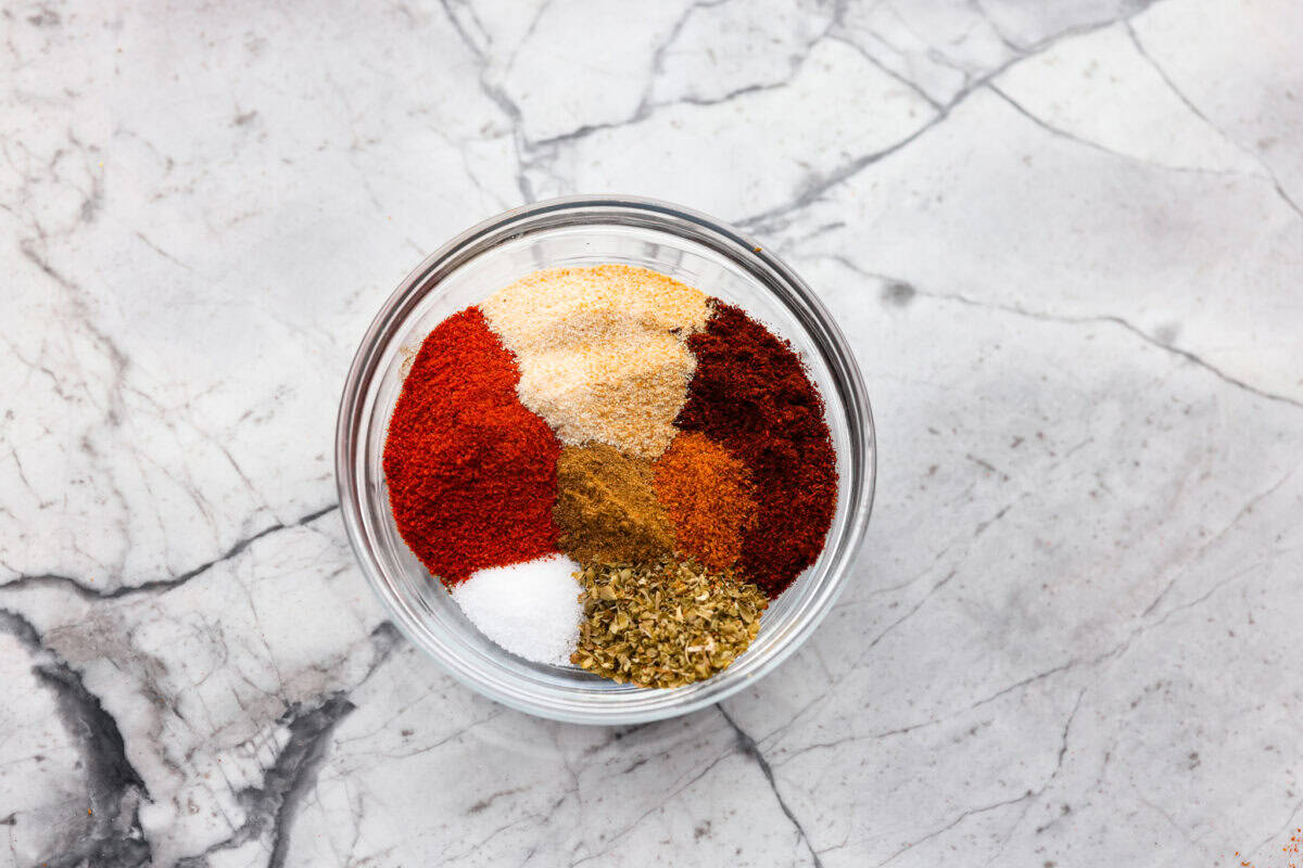 This homemade chili seasoning is the perfect blend of spices to give your chili bold, hearty flavor. Itโs quick to mix up, tastes way better than store-bought, and can be used in so many dishes! All of the seasoning ingredients in little piles in a bowl.