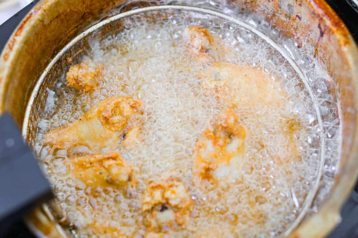 Meet your new wing obsession: Crack Wings. Salty, tangy, peppery, with a touch of sweetness. I've never seen a wing with a powder dusting so full of flavor! They are addictive because of the salty and sweet combo with that hint of heat. Chicken wings being deep fried in oil.
