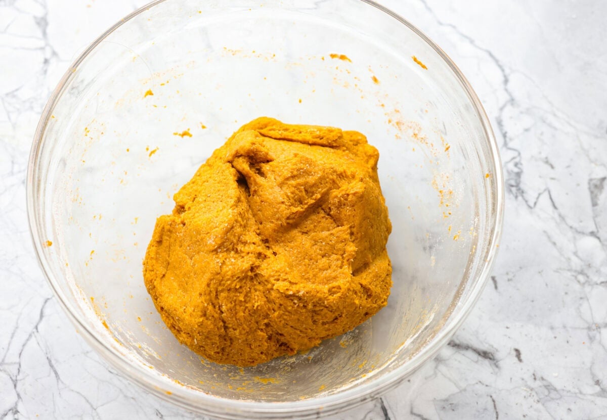 Get ready to spoil your furry friend! These homemade dog treats are made with simple ingredients and come together in no time. Your pup won’t stop begging for more! Bowl of wet and dry ingredients mixed together.