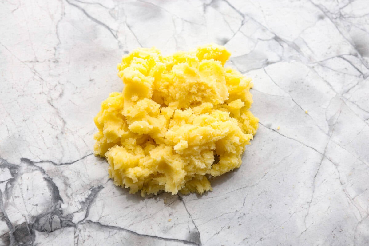 Homemade potato gnocchi is easier than you think! With just 5 simple ingredients, you can make soft, pillowy gnocchi at home. I’ll walk you through each step with clear instructions so you can master this classic Italian recipe on your first try. Potatoes mashed and in a pile.