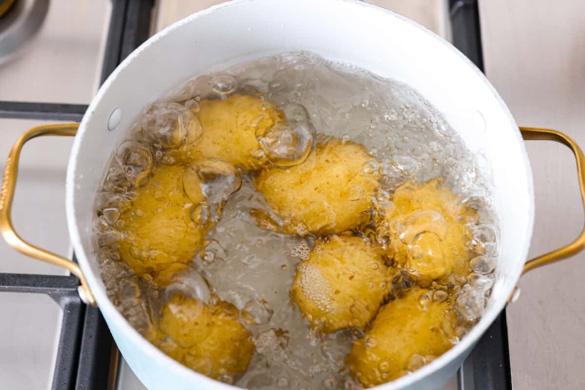 Homemade potato gnocchi is easier than you think! With just 5 simple ingredients, you can make soft, pillowy gnocchi at home. I’ll walk you through each step with clear instructions so you can master this classic Italian recipe on your first try. Whole potatoes boiling in water.