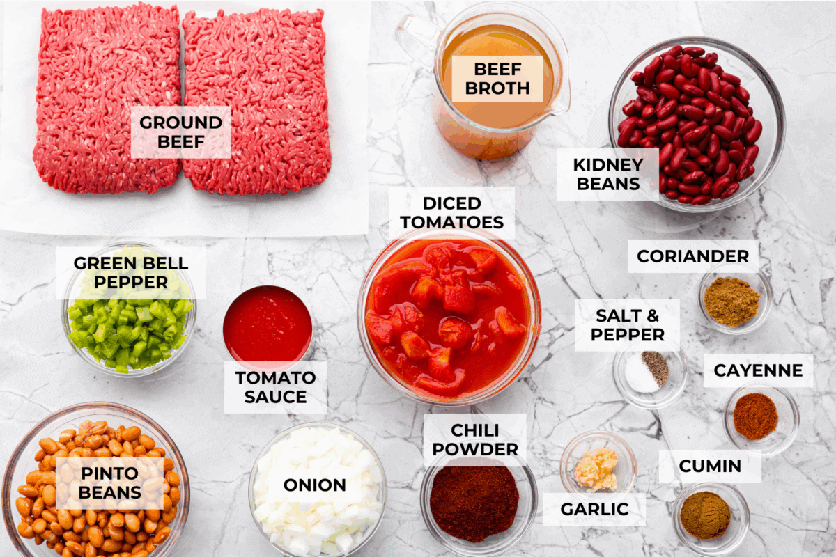 I'm telling you right now, this is the BEST chili you will ever have. The reviews don't lie! It's hearty, flavorful, and oh-so-comforting. It's packed with ground beef, beans, tomatoes, and bold spices. Get creative with your toppings and dig in! Overhead shot of labeled chili ingredients.