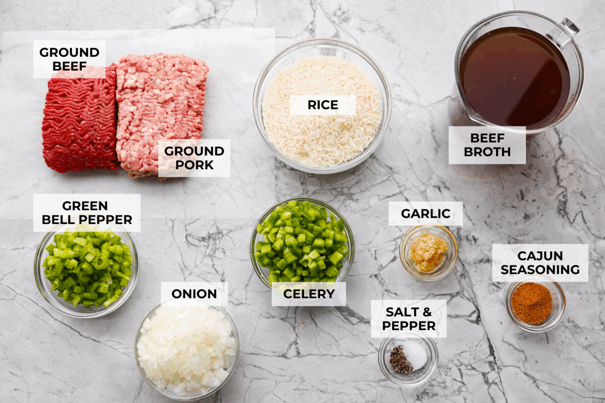 Why is it called โdirtyโ rice? The rice gets brown as it cooks with meat, Cajun spices, and the holy trinity of Cajun cooking: onion, bell pepper, and celery. My version combines ground pork and beef for a flavorful twist on this Louisiana classic! Overhead shot of labeled dirty rice ingredients.