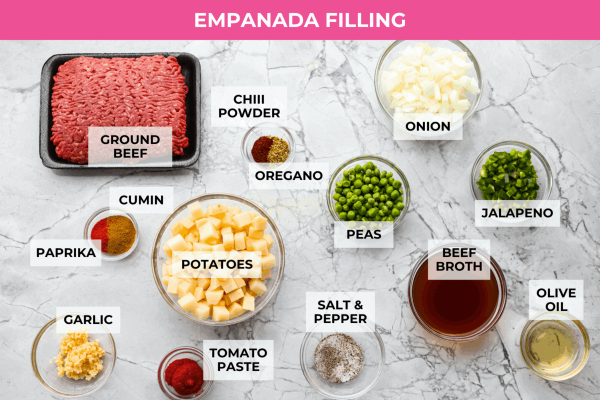 Okay, I just made homemade empanadas and Iโm obsessed! Crispy golden pockets stuffed with beef, potatoes, peas, and all the Mexican spices. You seriously need these in your life. Overhead shot of labeled empanada filling ingredients.