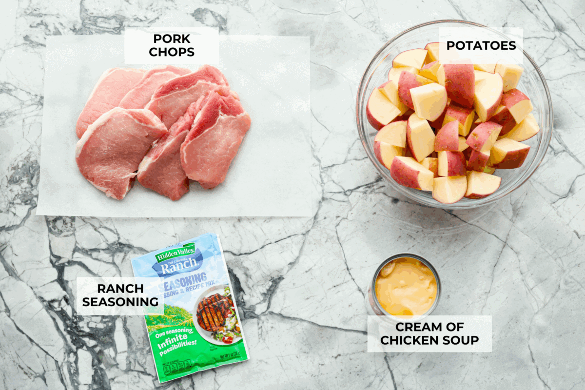 Weeknight magic in one pot! These slow cooker ranch pork chops are rich, comforting, and packed with flavor. With just a few ingredients, you’ll have tender pork and perfectly cooked potatoes swimming in a creamy ranch sauce. Overhead shot of labeled slow cooker ranch pork chops ingredients.