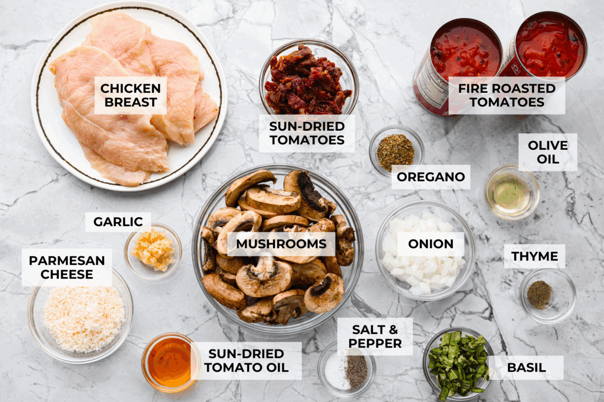 Tuscan garlic skillet chicken is one of those dinners I make and then wonder why I donโt make it more often. Juicy chicken and sun-dried tomatoes all cook together in one skillet. No heavy cream needed. Just fresh, bold flavor in 30 minutes! Overhead shot of labeled ingredients.