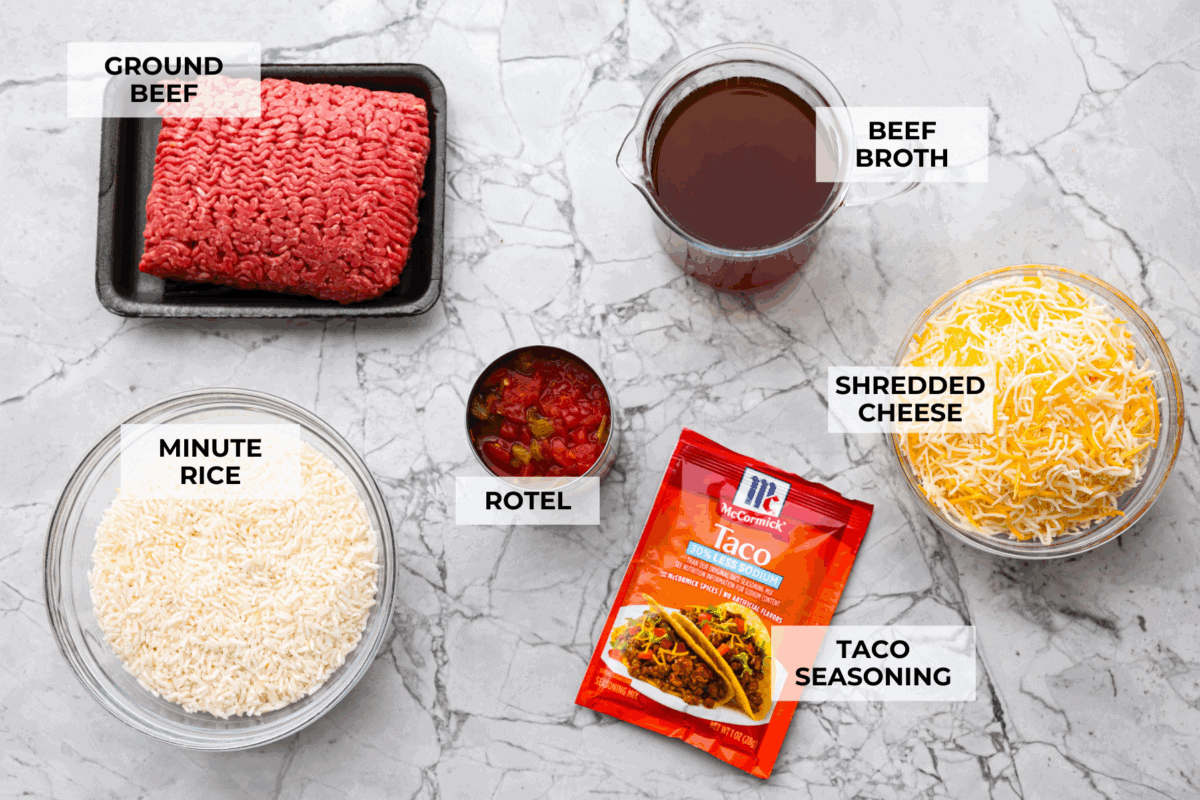 This is about to change your taco game forever! No shell needed! This dump-and-go taco rice is so easy and made with just 6 ingredients. Throw it together, top it your way, and boom, youโve got a totally unique and delicious taco night! Overhead shot of labeled taco rice ingredients.