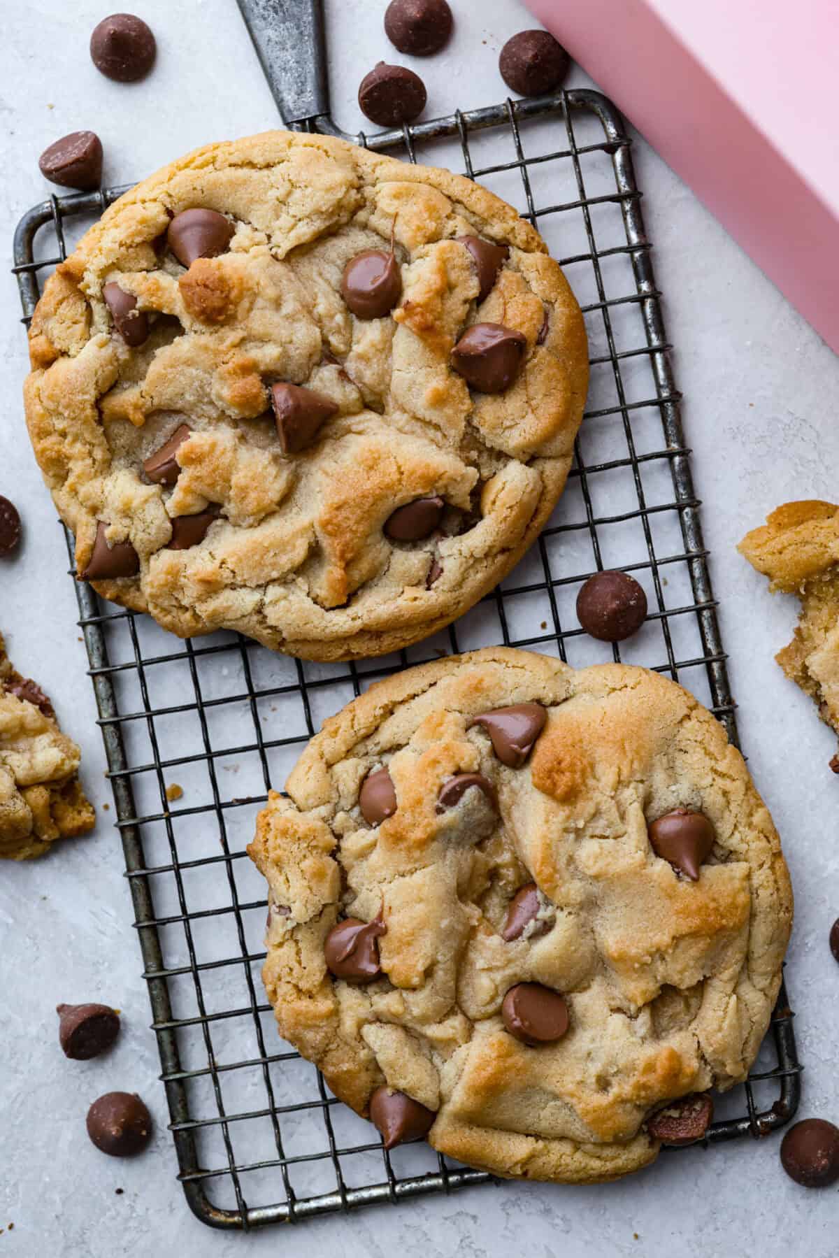 Two large copycat Crumbl cookies on a cooling rack. 