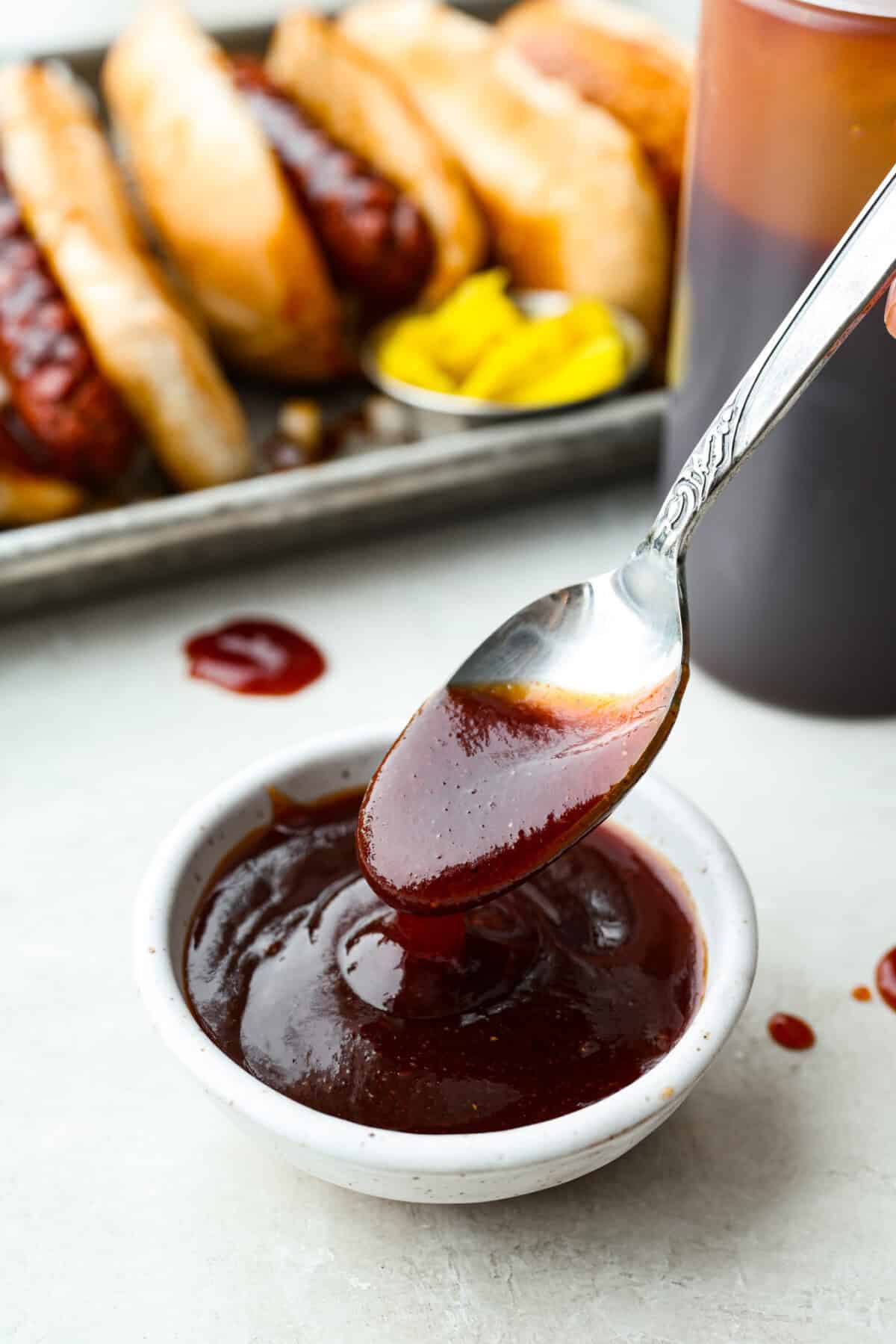 Here in Utah, J. Dawgs is basically a religion! Their hot dogs are THAT good. The sweet, tangy, smoky sauce? Life-changing! Make this copycat J Dawgs sauce at home and youโll never look at ketchup the same way again. Small bowl of J Dawgs sauce with a spoon.
