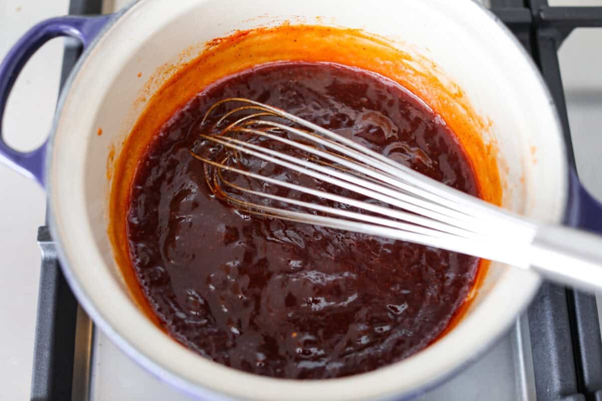 Here in Utah, J. Dawgs is basically a religion! Their hot dogs are THAT good. The sweet, tangy, smoky sauce? Life-changing! Make this copycat J Dawgs sauce at home and youโll never look at ketchup the same way again. All of the sauce ingredients combined into a pot and simmering on the stove.