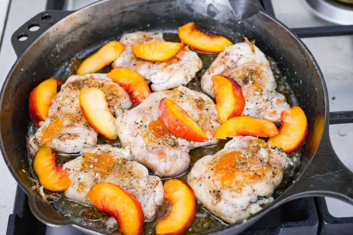 Sweet, savory, and full of summer vibes, peach chicken bakes up juicy and golden in a buttery peach preserve sauce with fresh peaches, Dijon, and a hint of garlic. Finished with basil, it’s simple, elegant, and packed with flavor! Chicken added back to the skillet with sliced peaches on top.