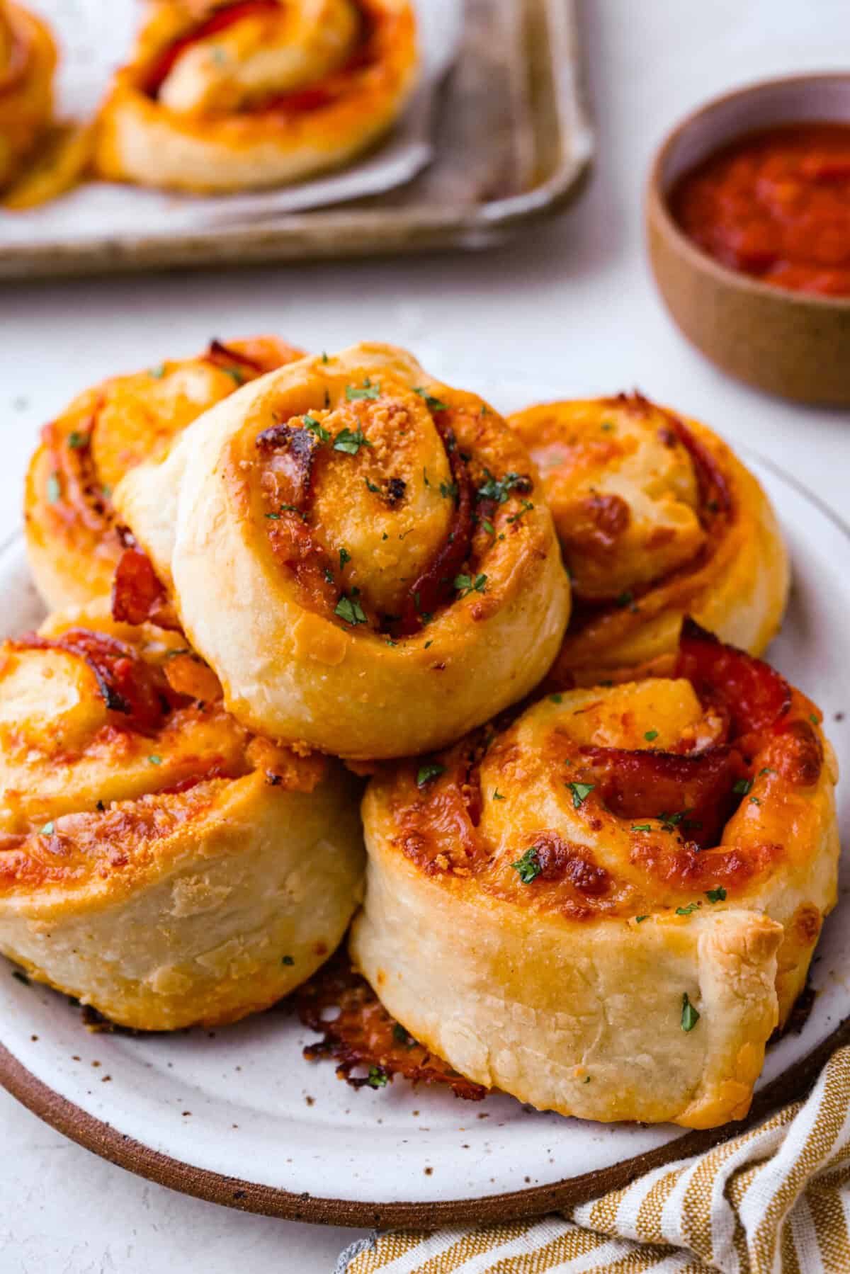 Ange shot of a plate full of pepperoni pizza rolls.