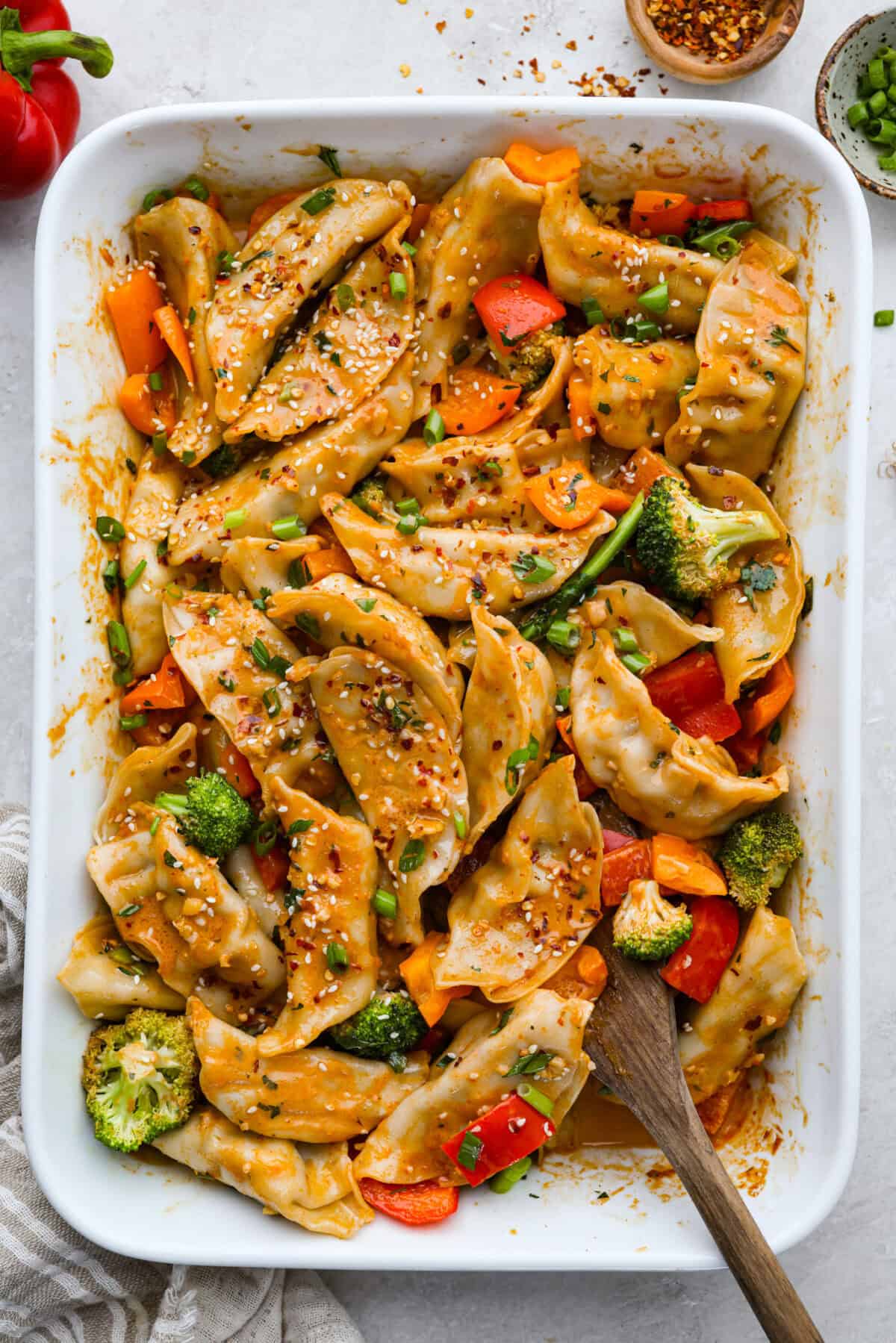 Potsticker casserole is all the tasty fun of potstickers in a warm, baked dish. Soft dumplings, fresh veggies, and a rich sauce cook together for a fast, easy, and filling meal. Overhead shot of potsticker casserole.