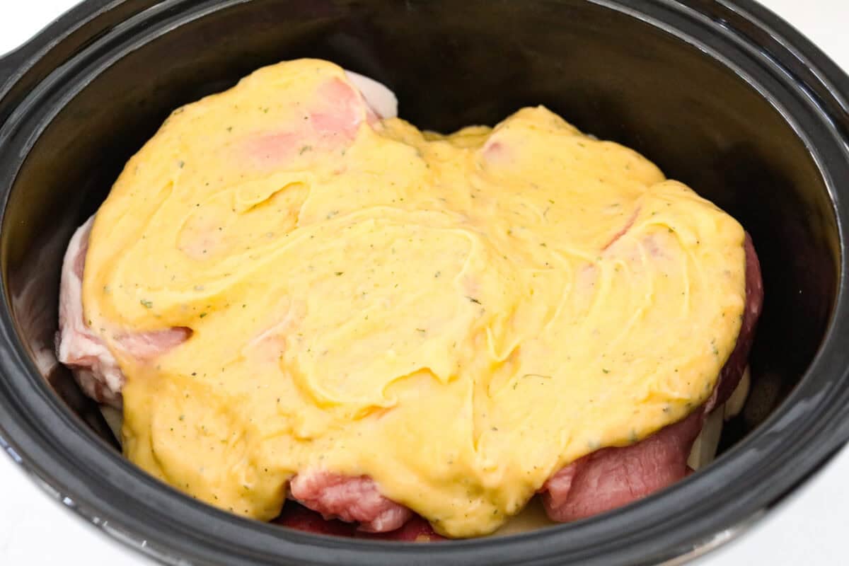 Weeknight magic in one pot! These slow cooker ranch pork chops are rich, comforting, and packed with flavor. With just a few ingredients, you’ll have tender pork and perfectly cooked potatoes swimming in a creamy ranch sauce. Soup mixture spread over the top of the pork chops.