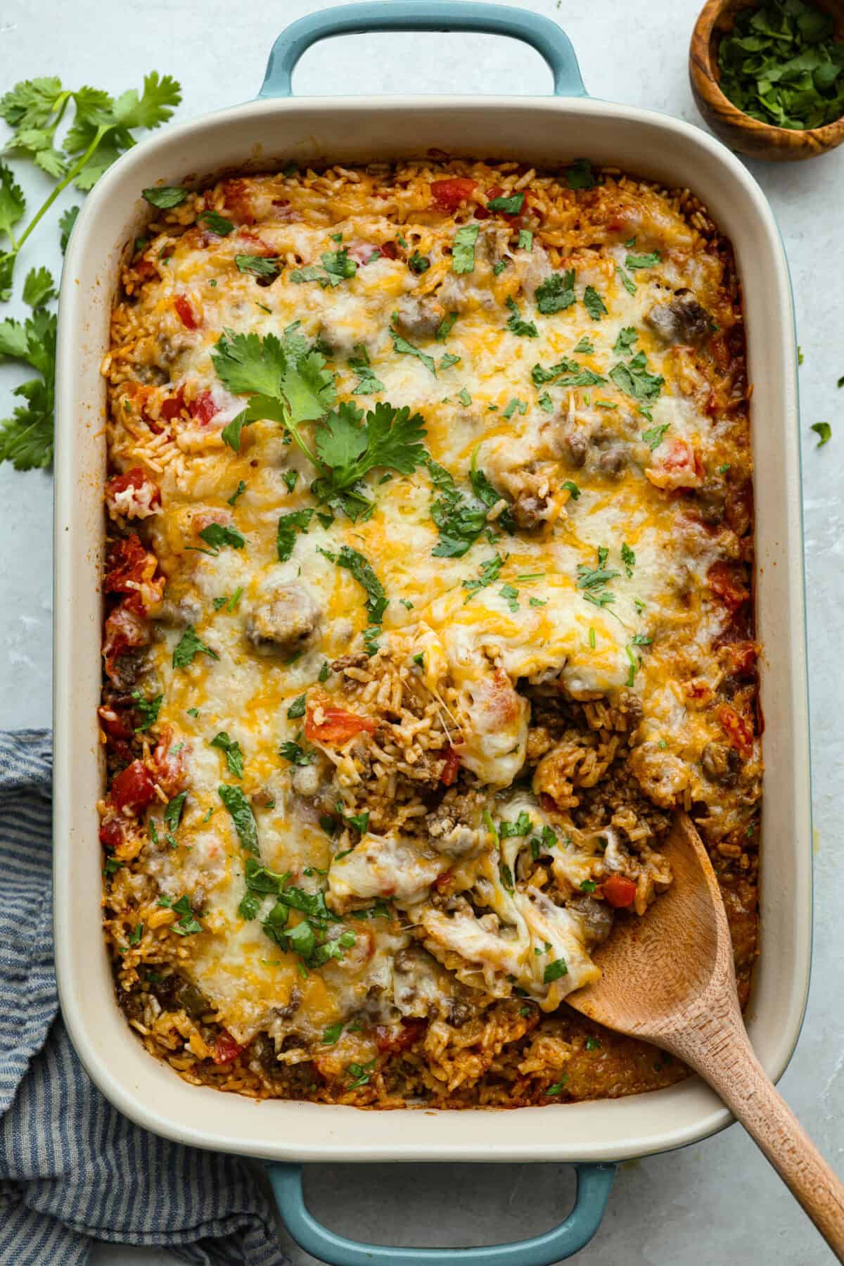 This is about to change your taco game forever! No shell needed! This dump-and-go taco rice is so easy and made with just 6 ingredients. Throw it together, top it your way, and boom, youโve got a totally unique and delicious taco night! Casserole dish of dump and go taco rice.