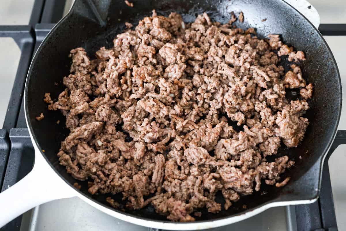 This is about to change your taco game forever! No shell needed! This dump-and-go taco rice is so easy and made with just 6 ingredients. Throw it together, top it your way, and boom, youโve got a totally unique and delicious taco night! Beef cooking in a skillet.