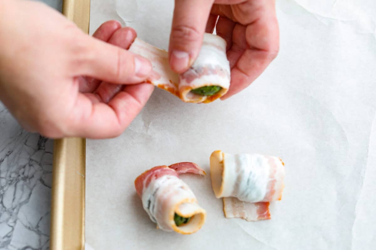 I love bacon. I love Brussels sprouts. Put them together and Iโm sold. But the secret to these bacon-wrapped Brussels sprouts? A drizzle of maple syrup! It makes them sweet, smoky, and completely irresistible. Someone wrapping the Brussels sprouts with bacon.