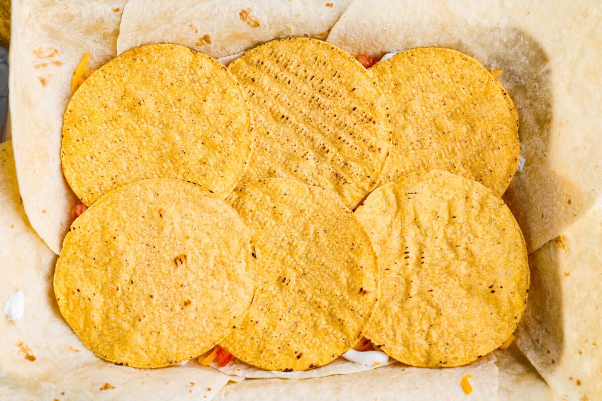 This TikTok-viral Crunchwrap Casserole takes Taco Bell’s iconic Crunchwrap Supreme and flips it into a cheesy, crunchy copycat casserole. It takes everything you love about the Crunchwrap and layers it into one big, family-sized dish! Tostada shells layered on top of the sour cream layer.