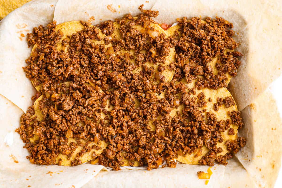 This TikTok-viral Crunchwrap Casserole takes Taco Bell’s iconic Crunchwrap Supreme and flips it into a cheesy, crunchy copycat casserole. It takes everything you love about the Crunchwrap and layers it into one big, family-sized dish! Seasoned ground beef layered over the top of the tostada shells.
