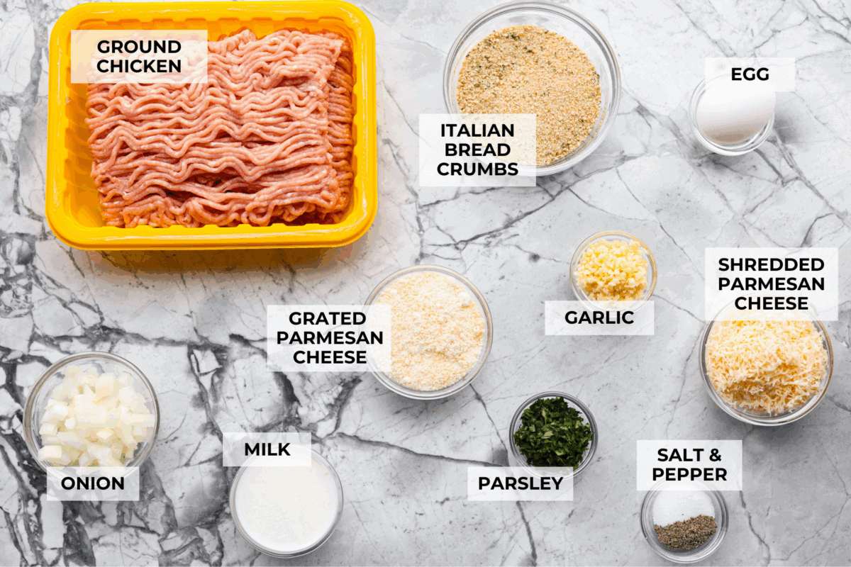 Meet your new favorite meatloaf! The ground chicken makes the Garlic Parmesan Chicken Meatloaf super moist, and you'll love the Parmesan herb-crusted topping! Overhead shot of labeled ingredients.